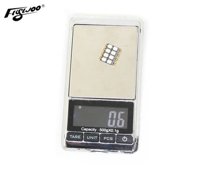 FLYWOO frame arm LED board light module on a digital scale showing 0.6 g weight