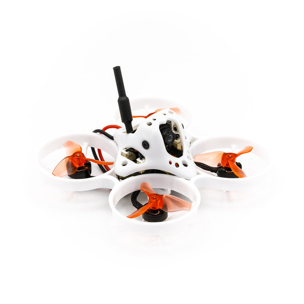 Angled side view of ducted micro quadcopter showing canopy, antenna, and orange tri-blade props