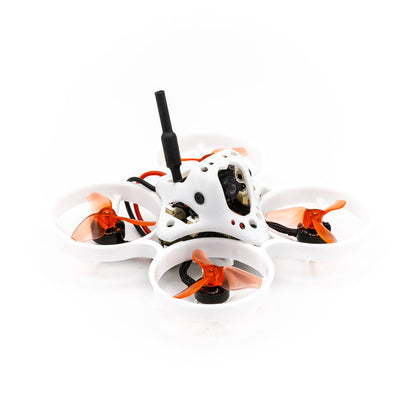 Angled side view of ducted micro quadcopter showing canopy, antenna, and orange tri-blade props