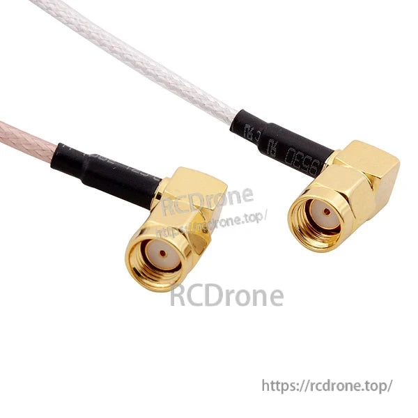 Close-up of two right-angle gold coax connectors on antenna leads, showing threaded ends and center pins