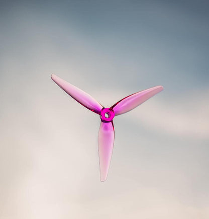 HQProp 5137 R37 5.1x3.7 tri-blade propeller in translucent purple, centered on gradient background