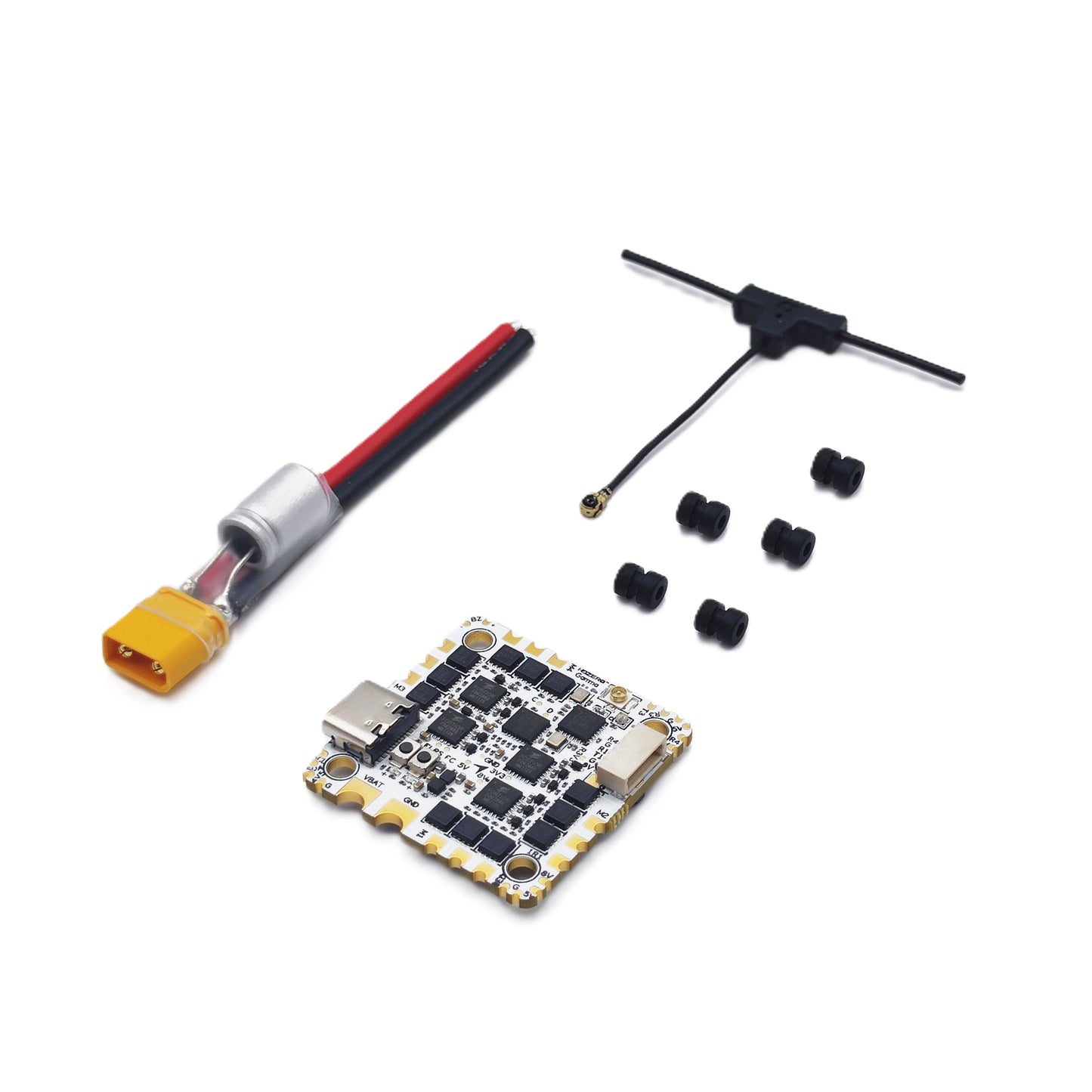 Package contents: AIO flight controller board, XT60 pigtail lead, antenna, and rubber grommets
