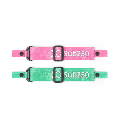 Pink and green Sub250 goggle straps laid flat with adjustment slider and end snaps