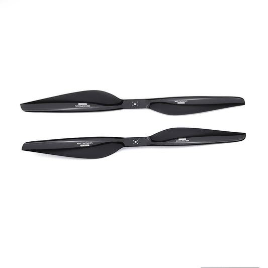 Pair of black carbon fiber drone propellers (CW and CCW) with mounting holes and branded hubs