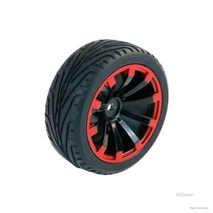 Rubber wheel with treaded tire and black hub, red rim accent, single wheel view
