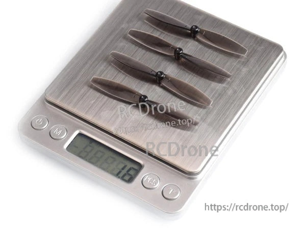 Four lightweight 65mm two-blade propellers on a digital scale showing total set weight