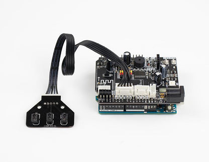 Tracking sensor module connected by ribbon cable to a controller board, showing wiring example