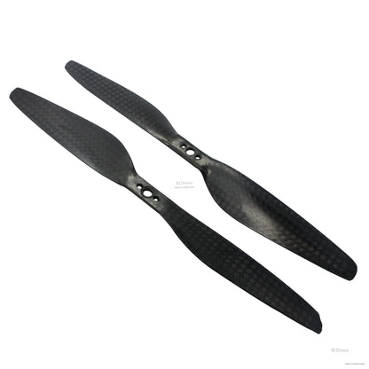 Black carbon fiber propeller pair on white background, showing blade shape and three-hole mounting hubs