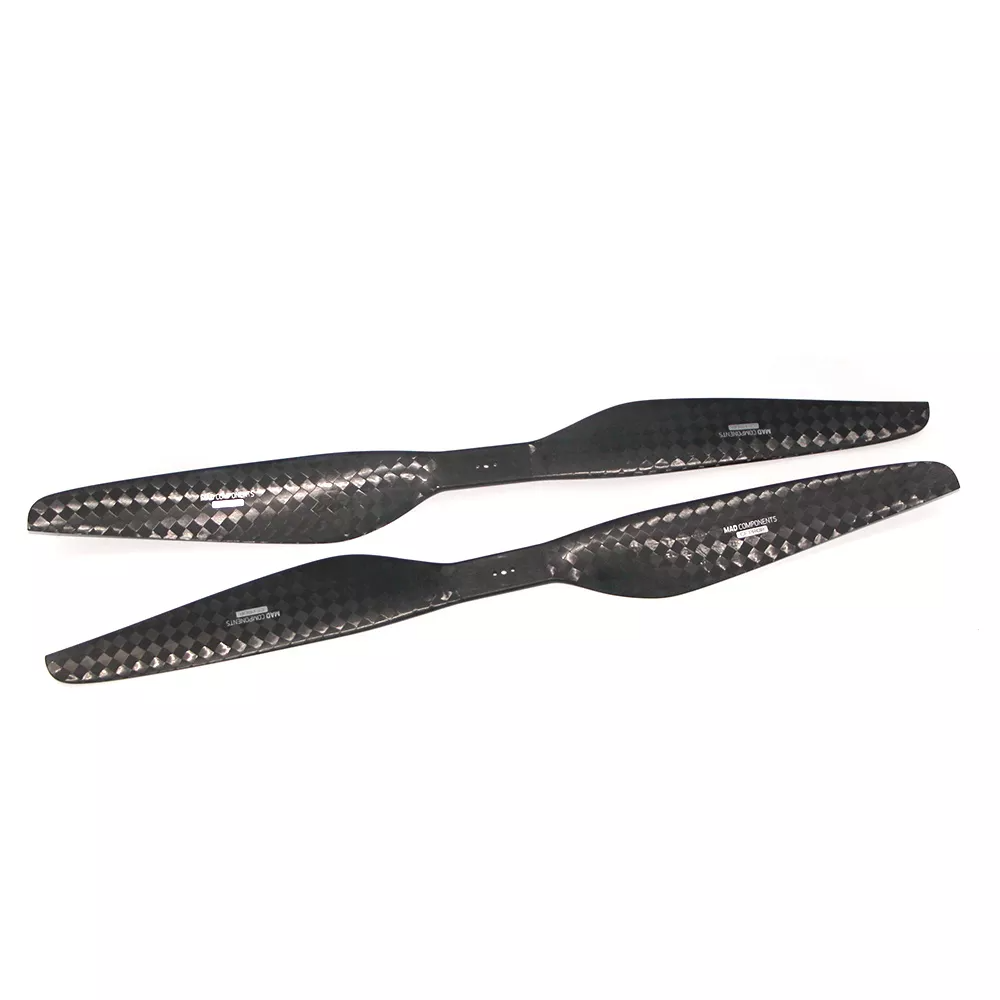 Pair of carbon fiber counter-rotating propeller blades with woven finish and center mounting holes