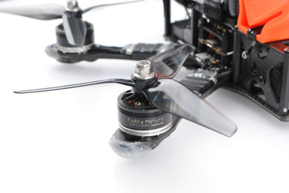 R42 3-blade propeller mounted on FPV quadcopter motor close-up, translucent grey blades