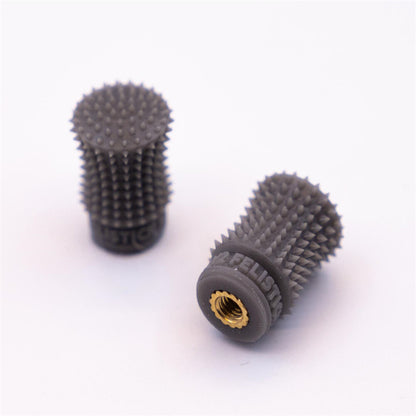 FeliStick spiked gimbal stick ends, pair shown on white background with brass threaded insert