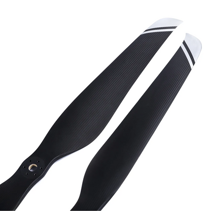 MAD FLUXER CB2 57x19 inch Carbon Fiber Propeller, Pair of black carbon fiber propeller blades with silver striped tips and mounting holes at the hub