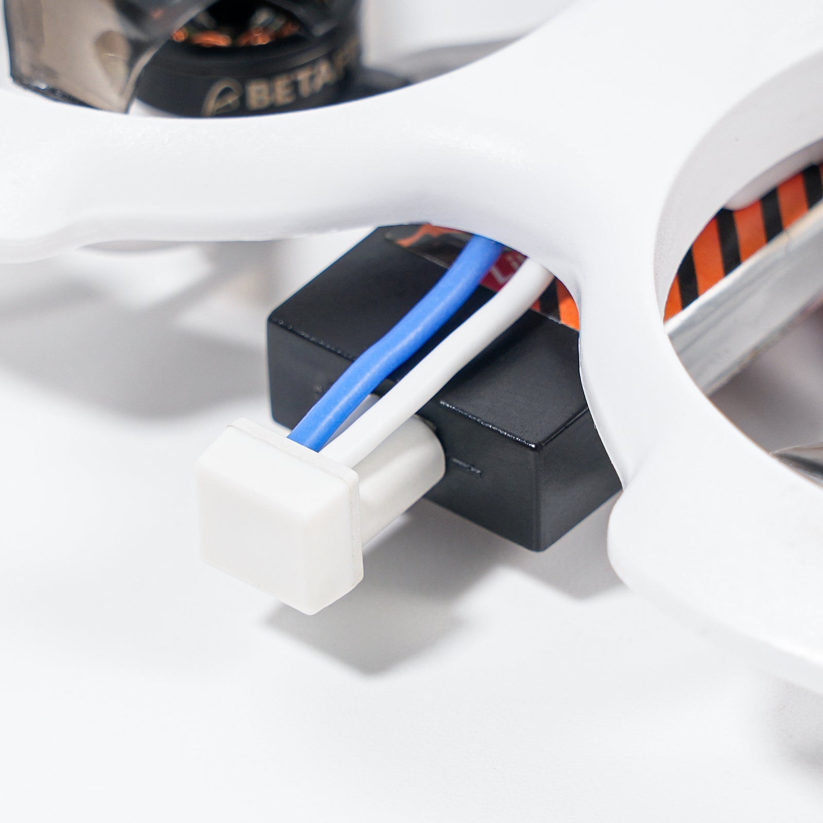 BT2.0 Whoop Cable connector plugged into a small drone power module, close-up installed view