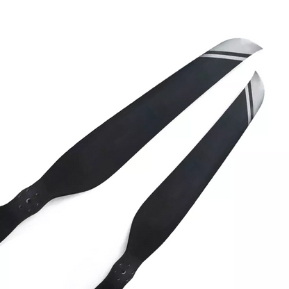 Pair of carbon fiber paramotor propeller blades with black finish and silver-striped tips
