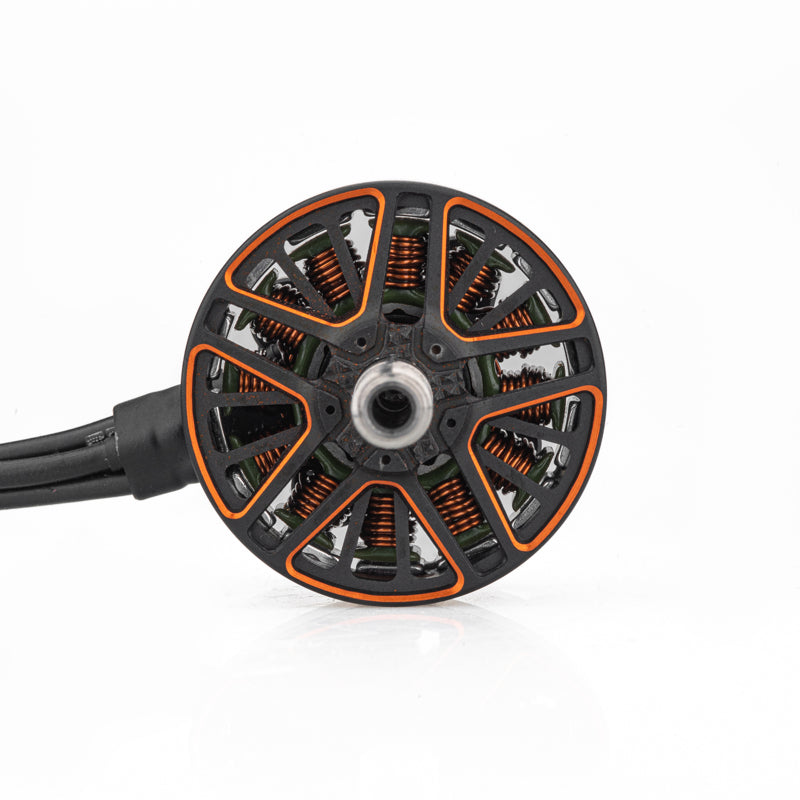 Top view of motor bell showing orange accents, copper windings, and three-wire lead exit