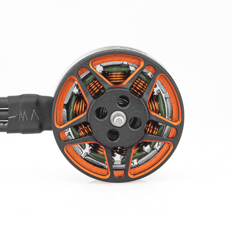 Top view of brushless motor showing orange rotor spokes, windings, and three-wire lead