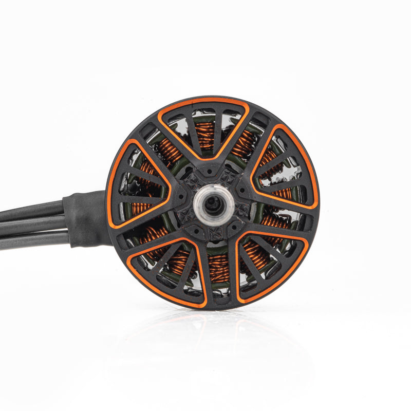 Top view of motor bell with orange spoke cutouts and center mounting hole, wires exiting left