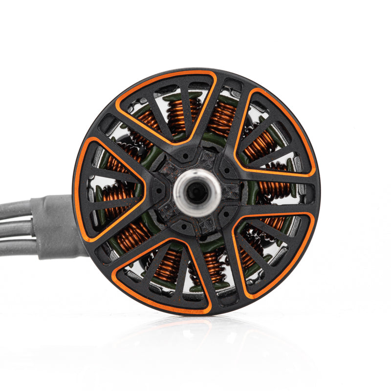 Top view of motor bell showing orange coil windings, ventilated spokes, and attached phase wires