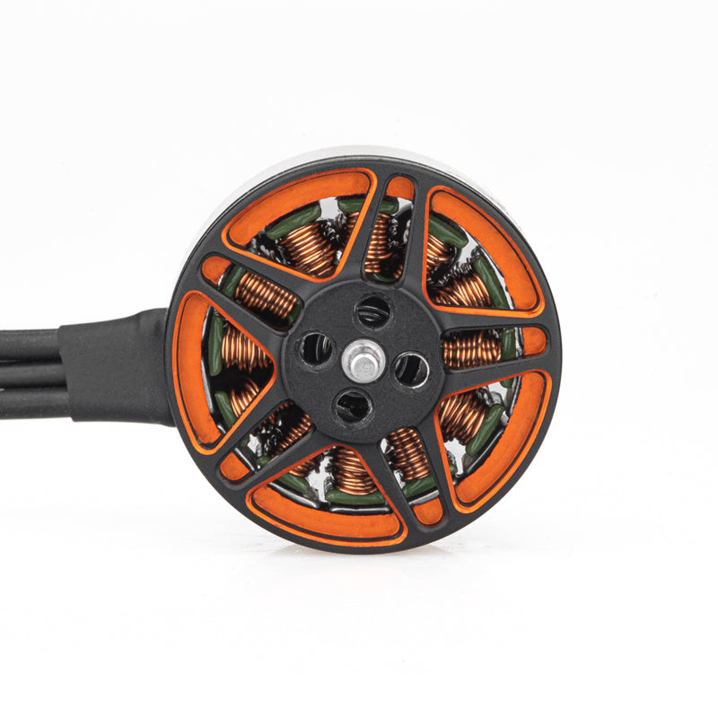 Top view of brushless motor rotor showing orange spokes, copper windings, and attached wires