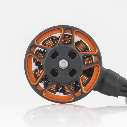 Top view of SPARK 1206 motor bell showing orange spokes, shaft center, and copper windings