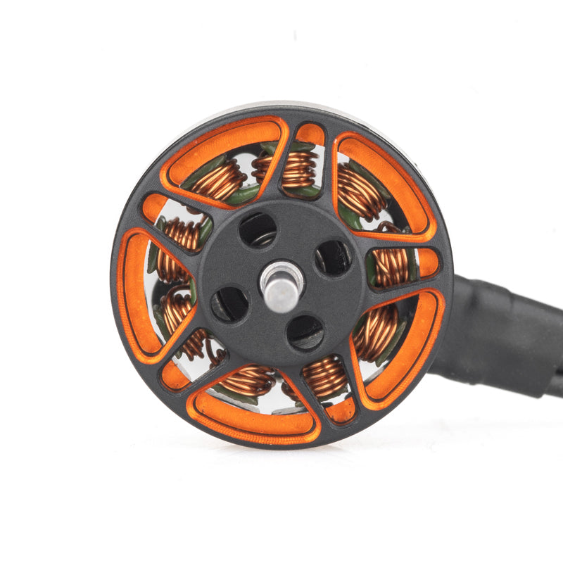Top view of SPARK 1202 motor showing orange bell cutouts, copper windings, and wire lead