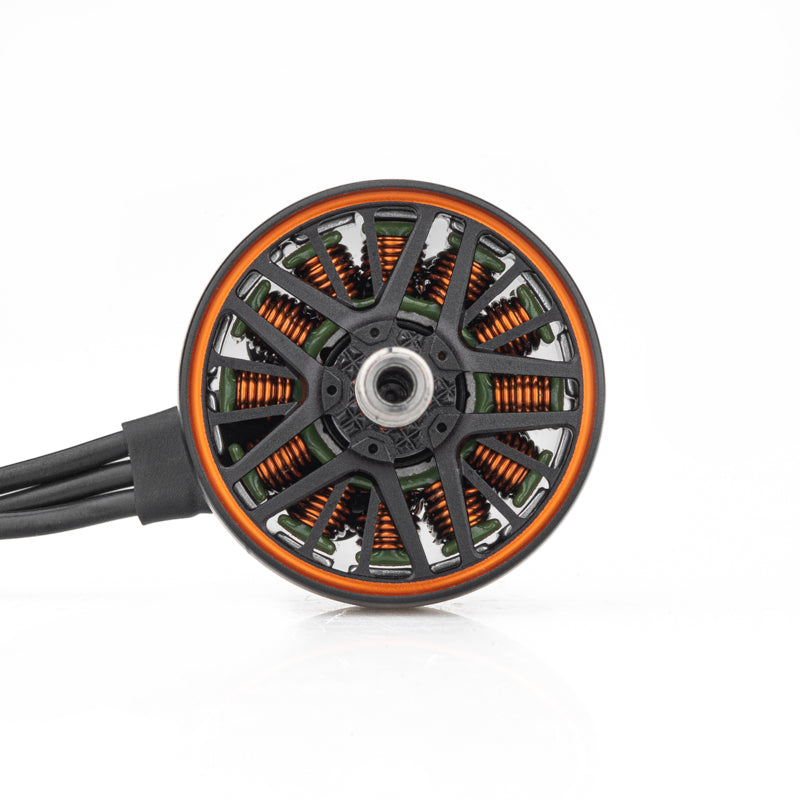 Top view of FPV brushless motor showing vented bell, copper windings, and three motor wires