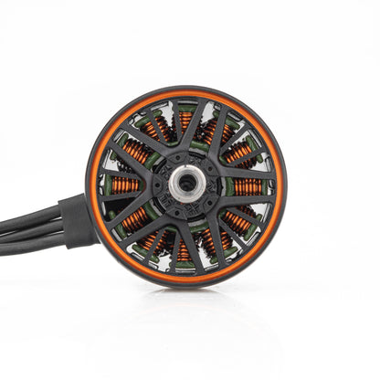 Top view of FPV brushless motor showing vented bell, copper windings, and three motor wires