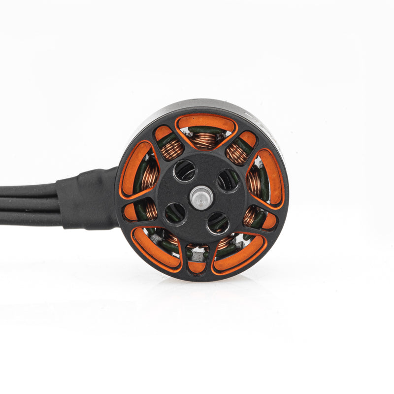 Top view of SPARK 1105 brushless motor showing orange frame cutouts, coils, and lead wires