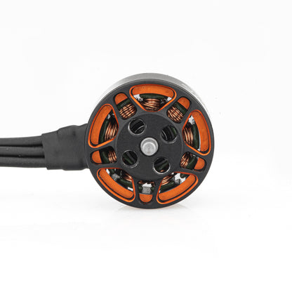 Top view of SPARK 1105 brushless motor showing orange frame cutouts, coils, and lead wires