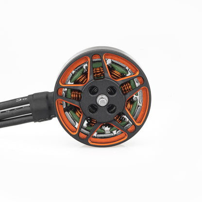 Top view of motor bell showing orange spokes, center mounting holes, and attached three-phase wires