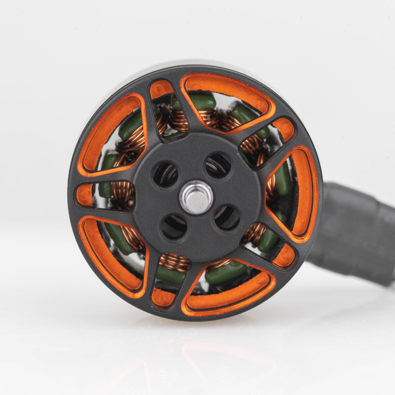 Top view of motor bell showing orange spoke design, copper windings, and center shaft