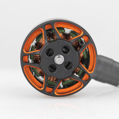 Top view of motor bell showing orange spoke design, copper windings, and center shaft