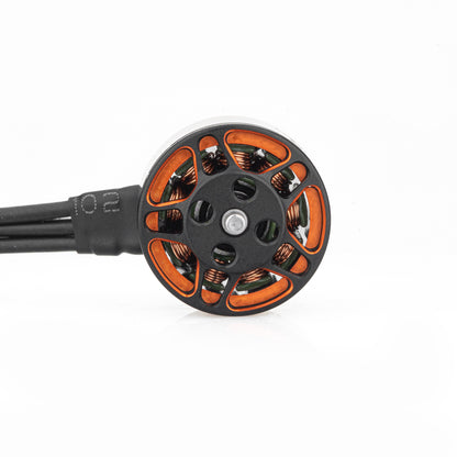 Top view of brushless motor showing vented bell, copper windings, and attached wire lead