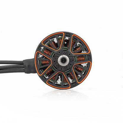 Top view of brushless motor bell showing copper windings, rotor vents, and three motor wires