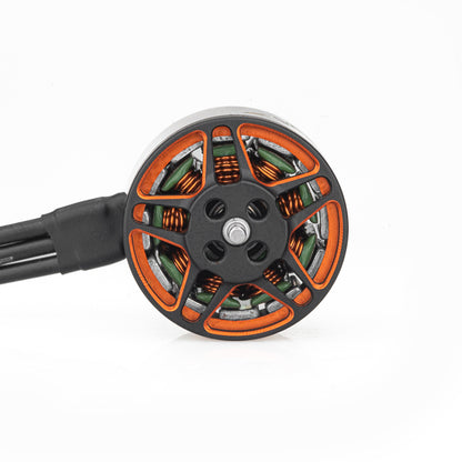 Top view of SPARK 1408 motor bell showing orange cutouts, copper windings, and lead wires