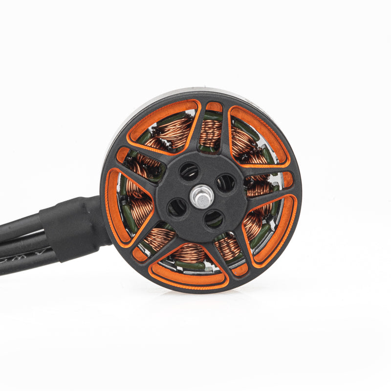Top view of motor bell showing orange cutouts, mounting holes, and copper windings