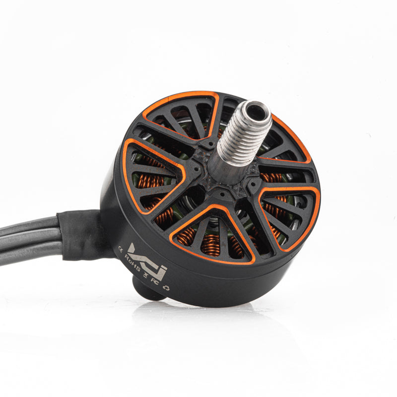 Angled top view of brushless motor with threaded shaft and orange vented bell, wires exiting from side