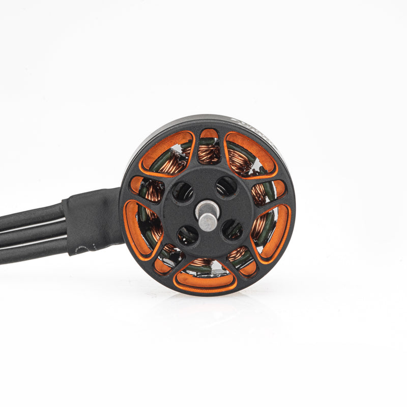 Top view of SPARK 1102 motor bell showing orange cutouts, copper windings, and three wires
