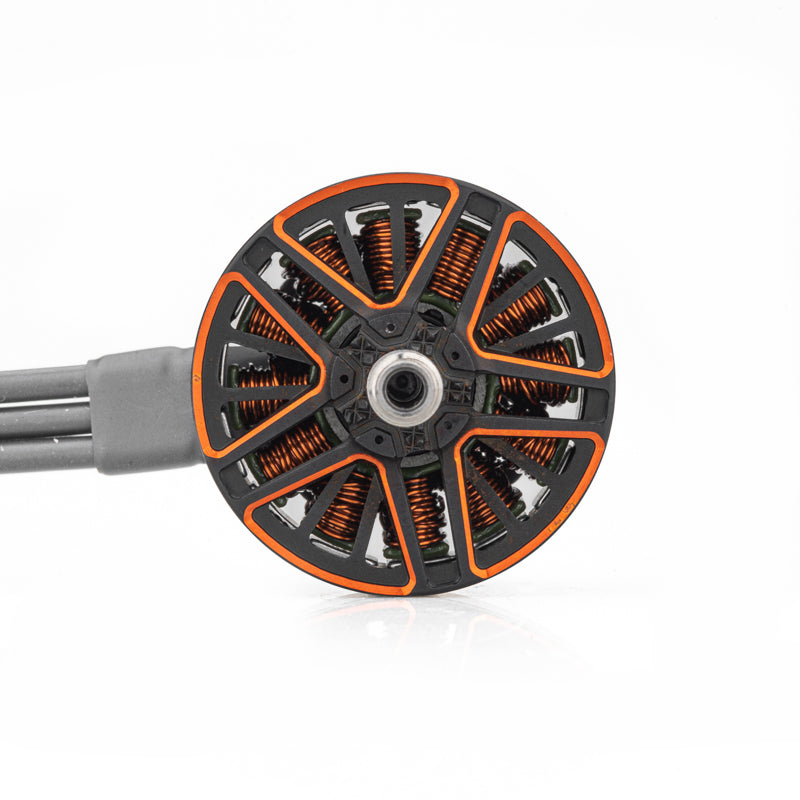 Top view of motor bell showing orange accents, cooling cutouts, and copper windings with lead wires