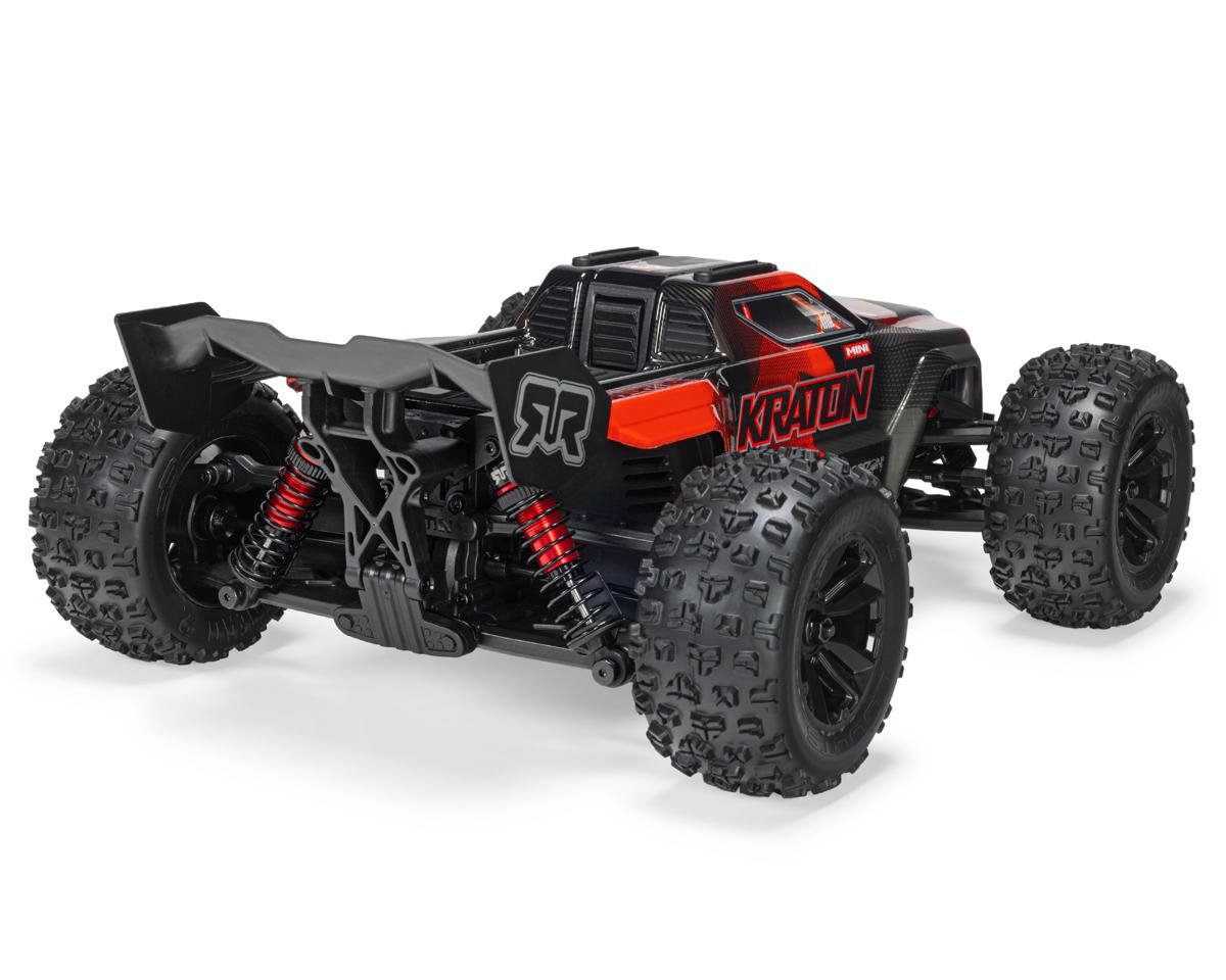 ARRMA Mini Kraton 1/16 4x4 RC monster truck in black and red with rear wing, coilover shocks and knobby tires