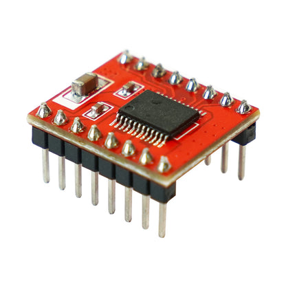 Red TB6612FNG driver breakout board angled close-up showing SMD chip and header pins