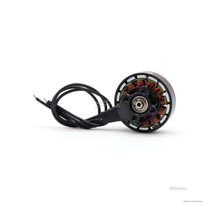 Bottom view of motor base showing copper windings, mounting hub, and attached lead wires