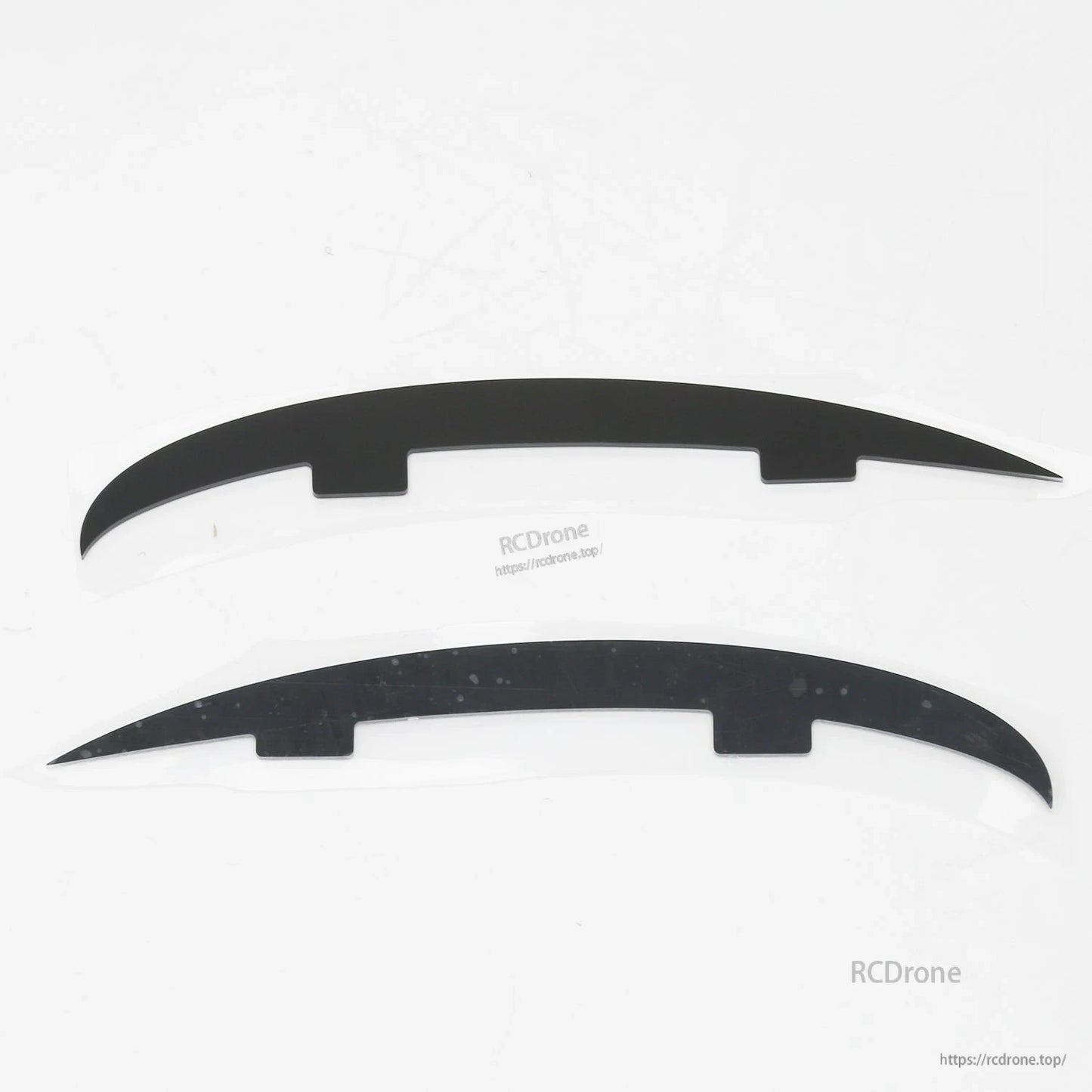 Pair of curved black plastic strips (landing skid or fairing pieces) for ATOMRC Beluga airframe