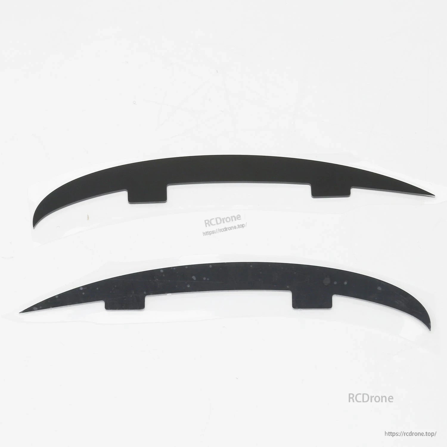 Pair of curved black plastic strips (landing skid or fairing pieces) for ATOMRC Beluga airframe