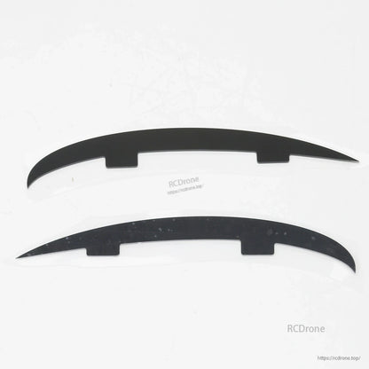 Pair of curved black plastic strips (landing skid or fairing pieces) for ATOMRC Beluga airframe