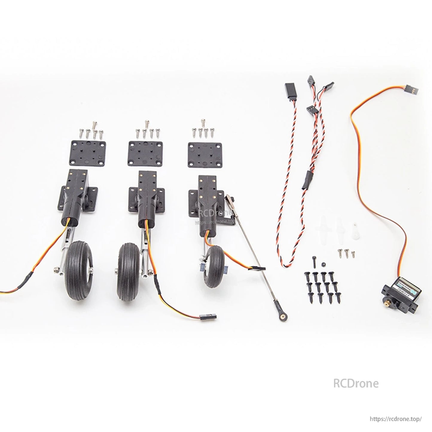 Retractable landing gear kit contents with three wheel struts, plates, screws, wiring harnesses and servo