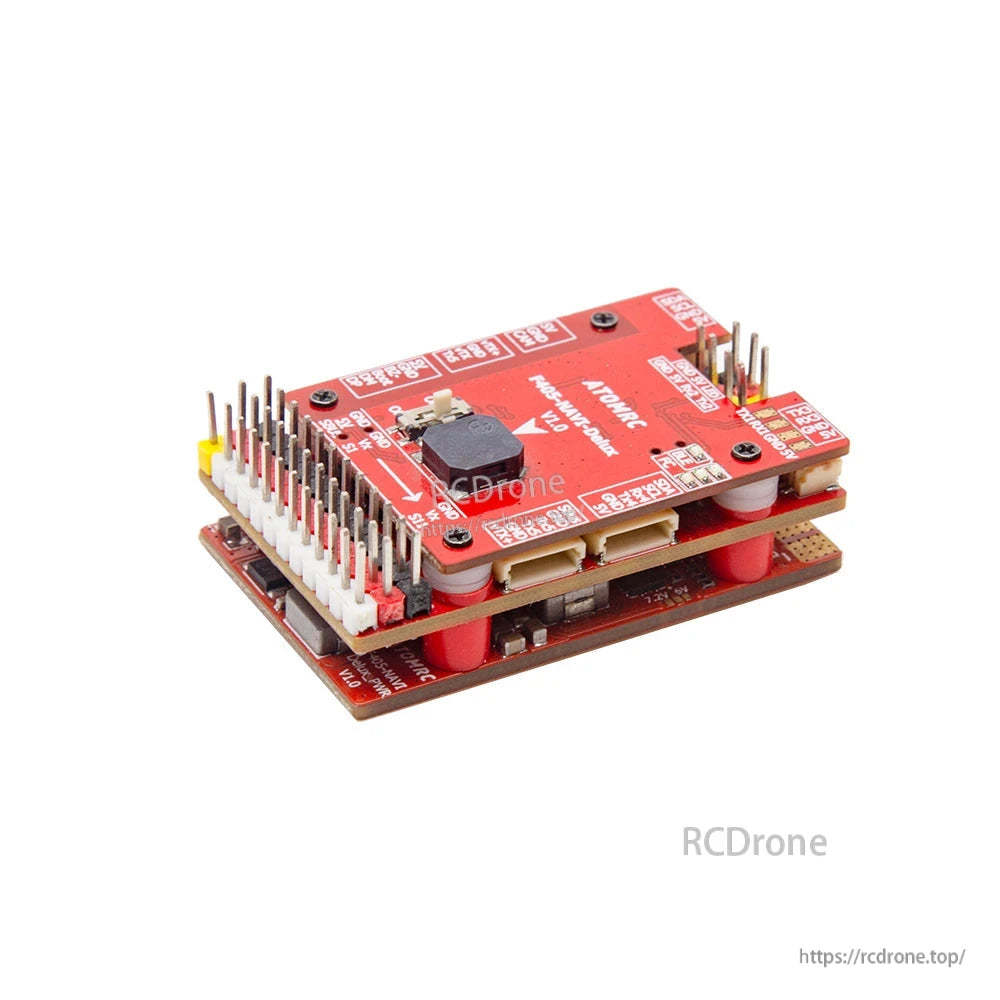 Angled view of stacked controller showing top button/module, long pin header bank, and mounting standoffs