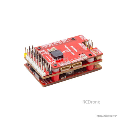 Angled view of stacked controller showing top button/module, long pin header bank, and mounting standoffs