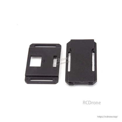 Two black mounting plates with slots and cutouts for RC aircraft accessory installation