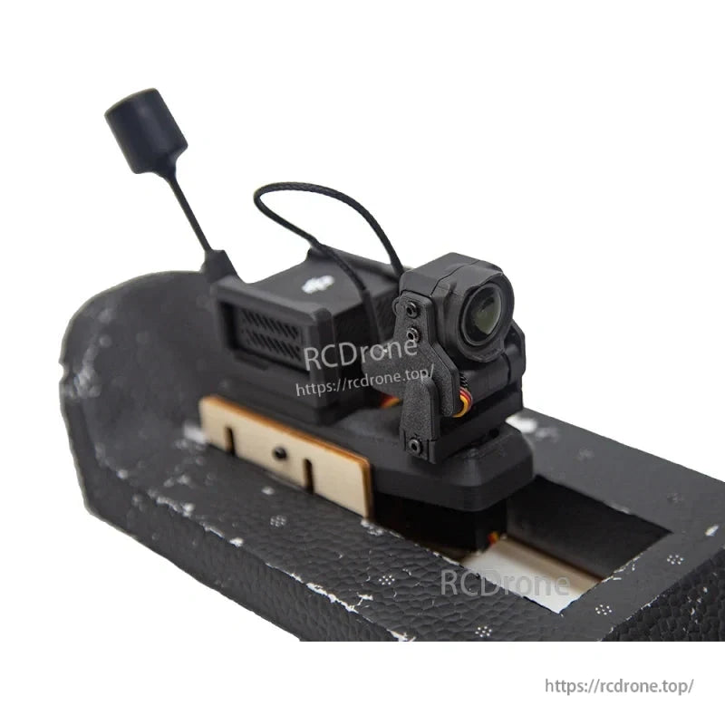 Servo gimbal mounted on foam platform, front-right angle with camera lens and antenna